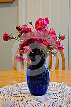 Bouquet of pink roses in a cobalt vase