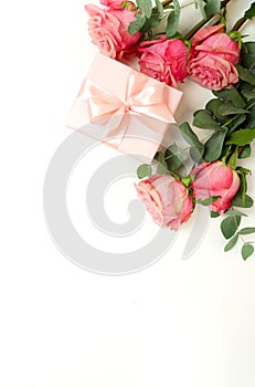 Bouquet of pink roses flowers, gift box  isolated on white background with copy space.