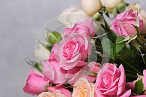 Bouquet of pink roses on a gray background, close-up.