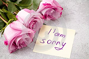 Bouquet of pink roses, a heart and a note with the inscription I love you on the table-the concept of love and care