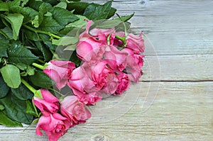 Bouquet of pink roses on old wooden background.Valentine`s Day,Mother`s Day or Birthday gift concept with copy space.
