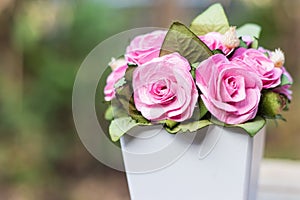 A bouquet of pink roses in pots.