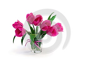 Bouquet pink tulips flowers in glass white vase with space for text on table on a white background with space for text