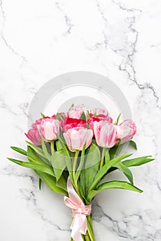Bouquet of pink tulips on marble background