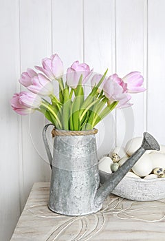 Bouquet of pink tulips in silver watering can