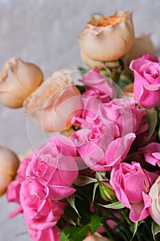Bouquet of pink and white roses on a light background.