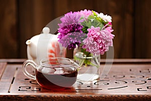 Bouquet of purple and pink asters and teaware for chinese tea ce