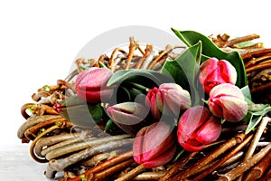 Bouquet of purple tulips in wicker wreath