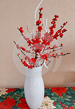 Bouquet of red berries in a vase.