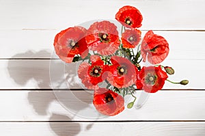 Bouquet of red poppies in glass vase