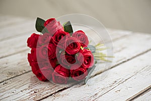 Bouquet of red roses on a grungy white wood