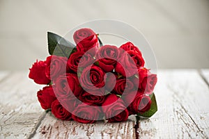 Bouquet of red roses on a grungy white wood