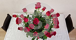 A bouquet of red roses on white table
