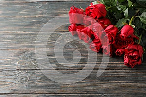 Bouquet red roses on wooden background
