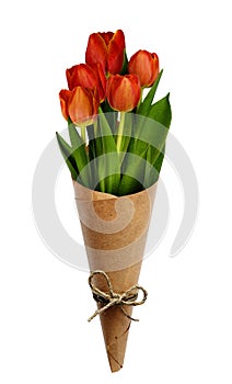 Bouquet of red tulip flowers in a craft paper cornet