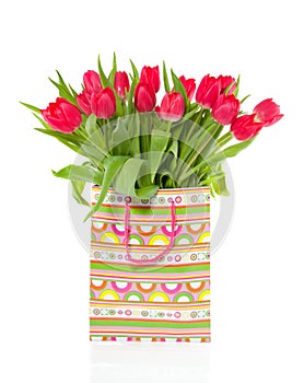 A bouquet of red tulips in a bag