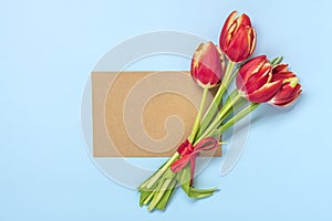 Bouquet of red tulips, card on blue background Top view Flat lay Holiday greeting card Happy moter's day, 8