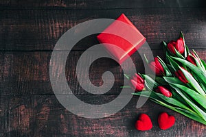 Bouquet of red tulips on a wooden background. Spring flowers. Mother's Day background.