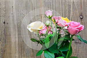 Bouquet of rose in a wooden background photo