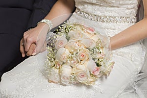 Bouquet with roses on the bride`s lap