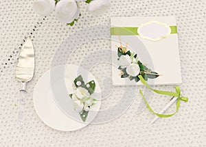 bouquet of roses and  cake on plate on the table in the garden