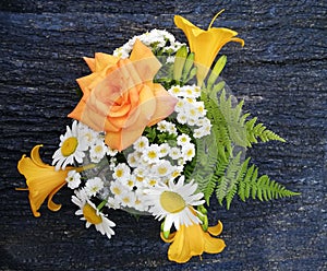 Bouquet of roses, chamomiles and daylilies.