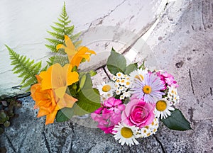 Bouquet of roses, chamomiles and daylilies.