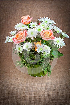 A bouquet of roses, chrysanthemums and pine needles