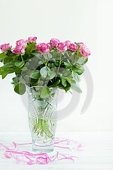 A bouquet of roses in a crystal vase
