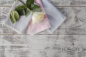 Bouquet of roses decorated with lace on white wooden background