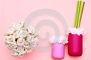 Bouquet of roses, flowers on the jars with pink background, mothers day celebration, flat lay top view