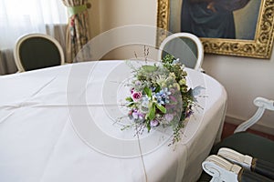 Bouquet of roses, forget-me-not, clover lying on table