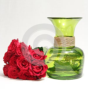 A bouquet of roses and green vase