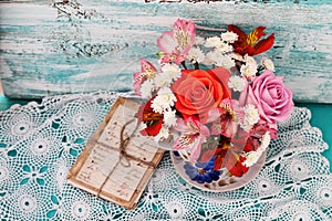 Bouquet roses and old letters on wooden desk in a vintage style.