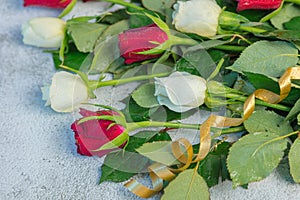 bouquet of roses, red and white. On a gray background. Congratulations to March 8 with Denm Birthday, Anniversary. ... photo