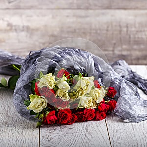 Bouquet of roses on the table. Multicolored roses