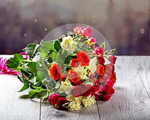 Bouquet of roses on the table. Multicolored roses