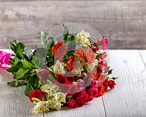 Bouquet of roses on the table. Multicolored roses