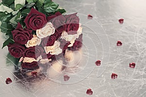 Bouquet of roses of two colors for beloved, many red hearts, symbol of love,Valentine`s feast and romantic celebrations