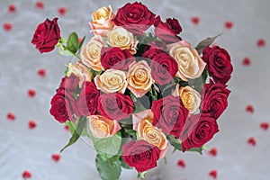 Bouquet of roses of two colors for beloved, many red hearts, top view, symbol of love,Valentine`s feast and romantic