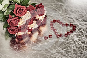 Bouquet of roses of two colors for beloved and red heart, symbol of love, Valentine`s feast, other romantic celebrations