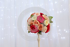 Bouquet of roses in a vase on the background of a silk curtain