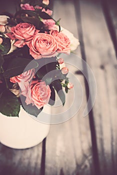 Bouquet of roses in vintage coffee pot