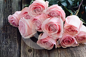 Bouquet of roses on wooden table