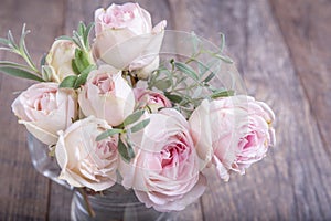 Bouquet of roses on wooden table