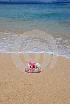 Bouquet on the sandy beach with gentle waves