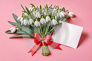 Bouquet of snowdrops tied with a red ribbon and a note attached to the bouquet. Martisor and Baba Marta