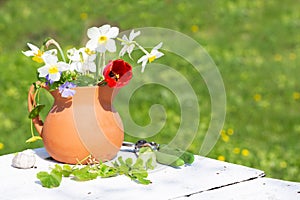 Bouquet of spring flowers in a ceramic jug