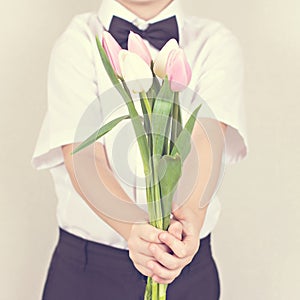 Bouquet of spring flowers in children's hands.