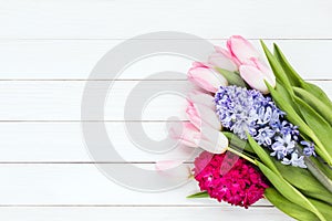 Bouquet of spring flowers on white wooden background